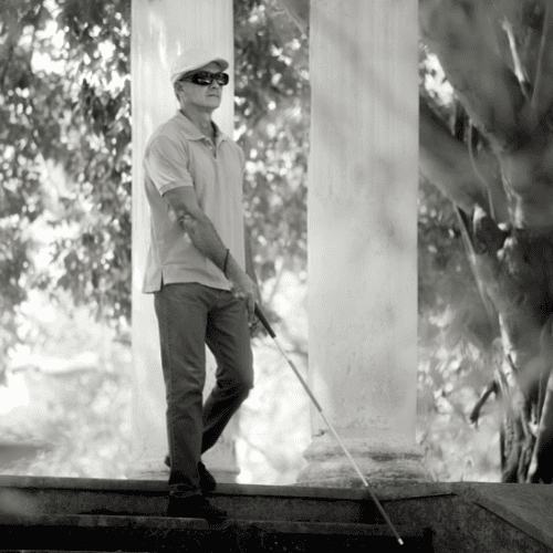 Blind Man walking with a cane.